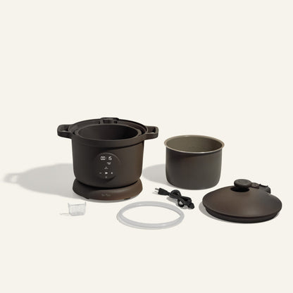 Black dream cooker non toxic pressure cooker with parts laid out