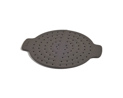 The Fearless Fry is a round, dark gray silicone steamer basket with handles and evenly spaced holes, designed for steaming food in your Always Pan while helping to prevent splatter.