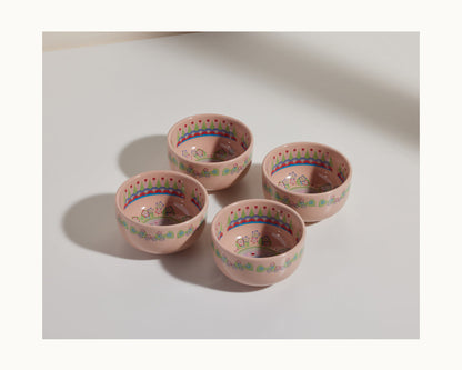 The Rice Bowl Set includes four pink stoneware bowls with decorative patterns and small floral designs, arranged in a square—ideal for Lunar New Year or Year of the Rabbit celebrations.