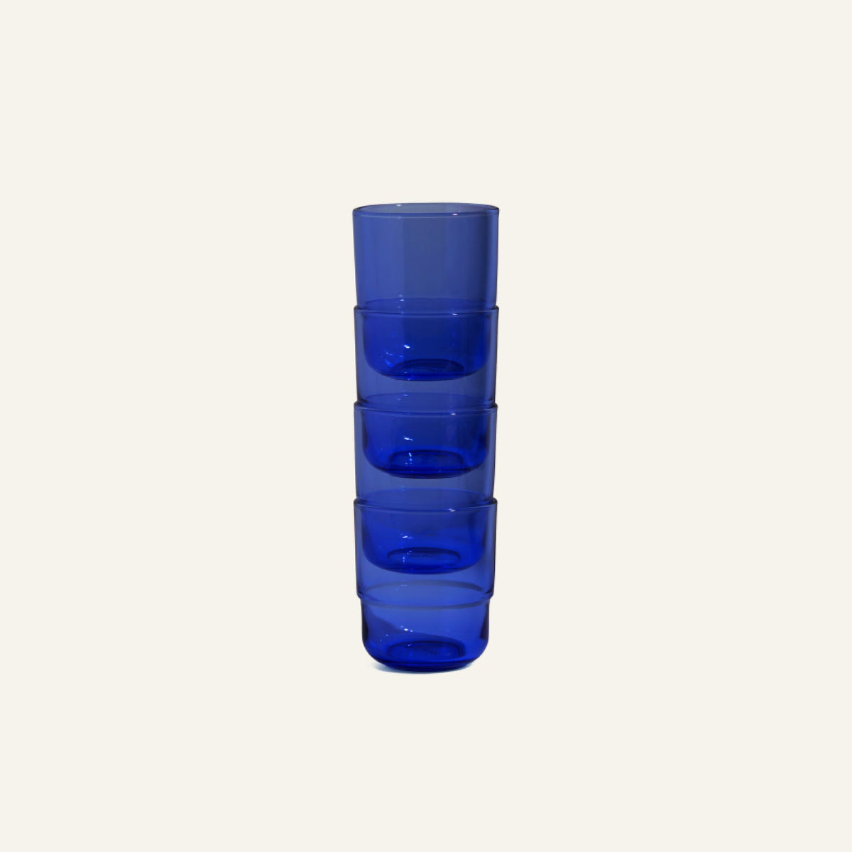 A set of four Short Night + Day Glasses is stacked vertically against a plain light background.
