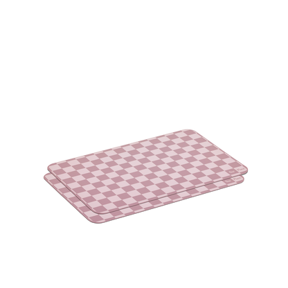 Two rectangular Oven Mats in pink and purple checkered designs are stacked on a white background—reusable silicone mats ideal for adding vibrant color to your kitchen.