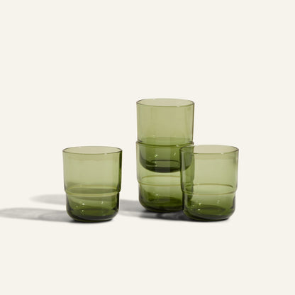 Four Short Night + Day Glasses, handmade from recycled glass with a subtle green tint, are arranged on a plain light background—two stacked and two side by side.