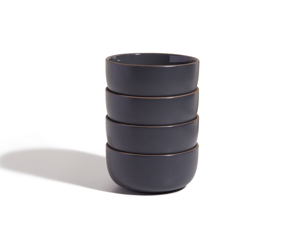 Four stackable Soup Bowls in dark gray sit on a white surface, casting a left-side shadow—ideal for adding style to your tableware collection.