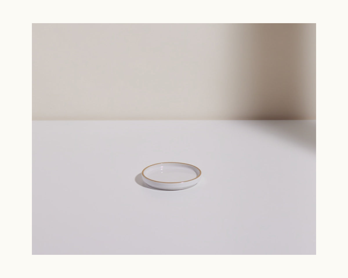 The Tiny Plates, small and round with a gold rim, are displayed on a white surface against a neutral background—perfect for elevating any tableware set.