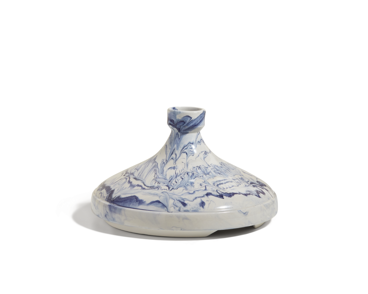 Introducing the Tagine: a white ceramic vase with a wide, flat base and narrow neck, adorned with a blue marbled pattern inspired by handcrafted Moroccan pottery.