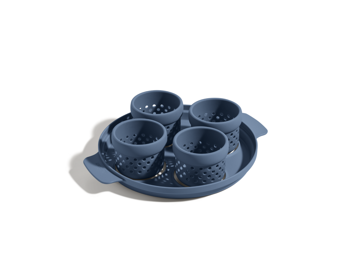 The Egg Poacher features four blue perforated silicone cups in a round tray, ideal for making poached eggs. Shown on a white background.