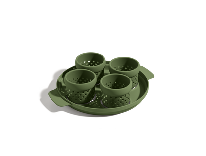 The Egg Poacher includes four green silicone cups in a matching round handled tray, perfect for steaming or cooking poached eggs, shown on a white background.