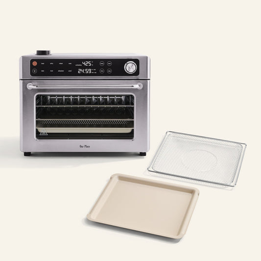 The Wonder Oven Pro + Wonder Oven Pro Essentials Kit, featuring a digital display, is displayed on a white surface with its wire rack and baking tray.