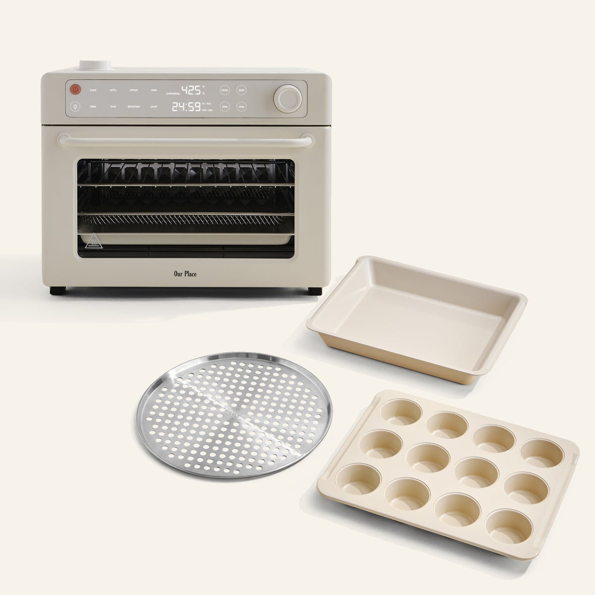 The Wonder Oven Pro + Wonder Oven Pro Chef's Kit is displayed with a baking pan, muffin tray, and perforated tray, all set against a light background.