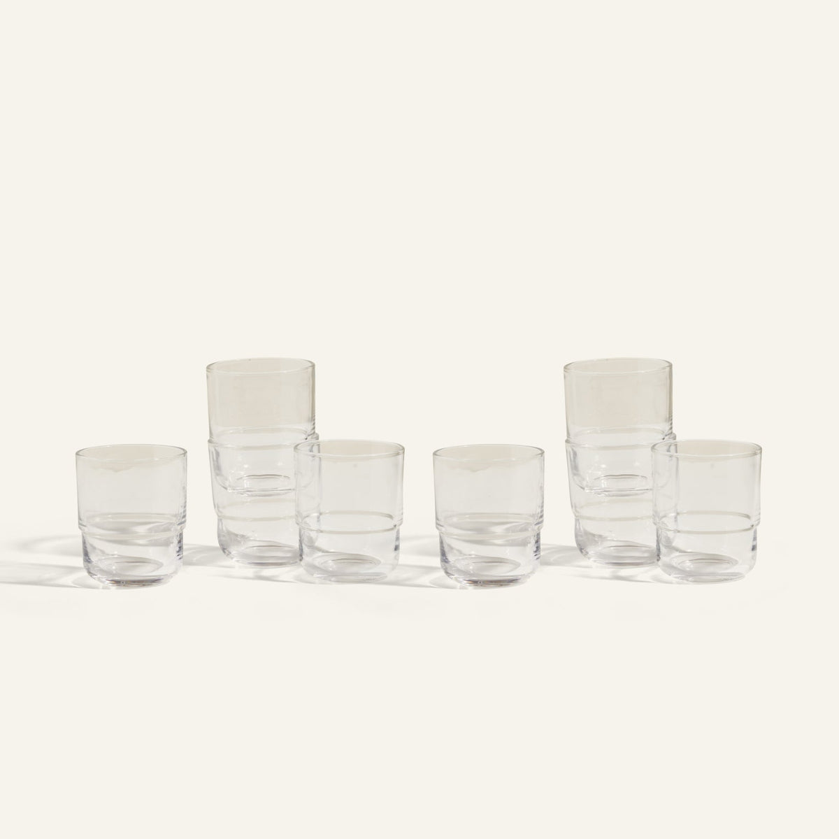 Six clear, empty Short Night + Day Glasses are arranged in two rows on a light background; three are stacked in pairs and three stand alone, highlighting these versatile handmade tumblers perfect for any occasion.
