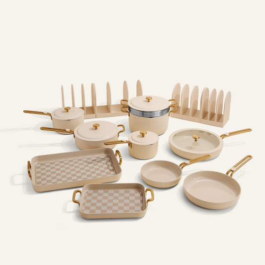 Set of beige cookware with gold handles on a white background