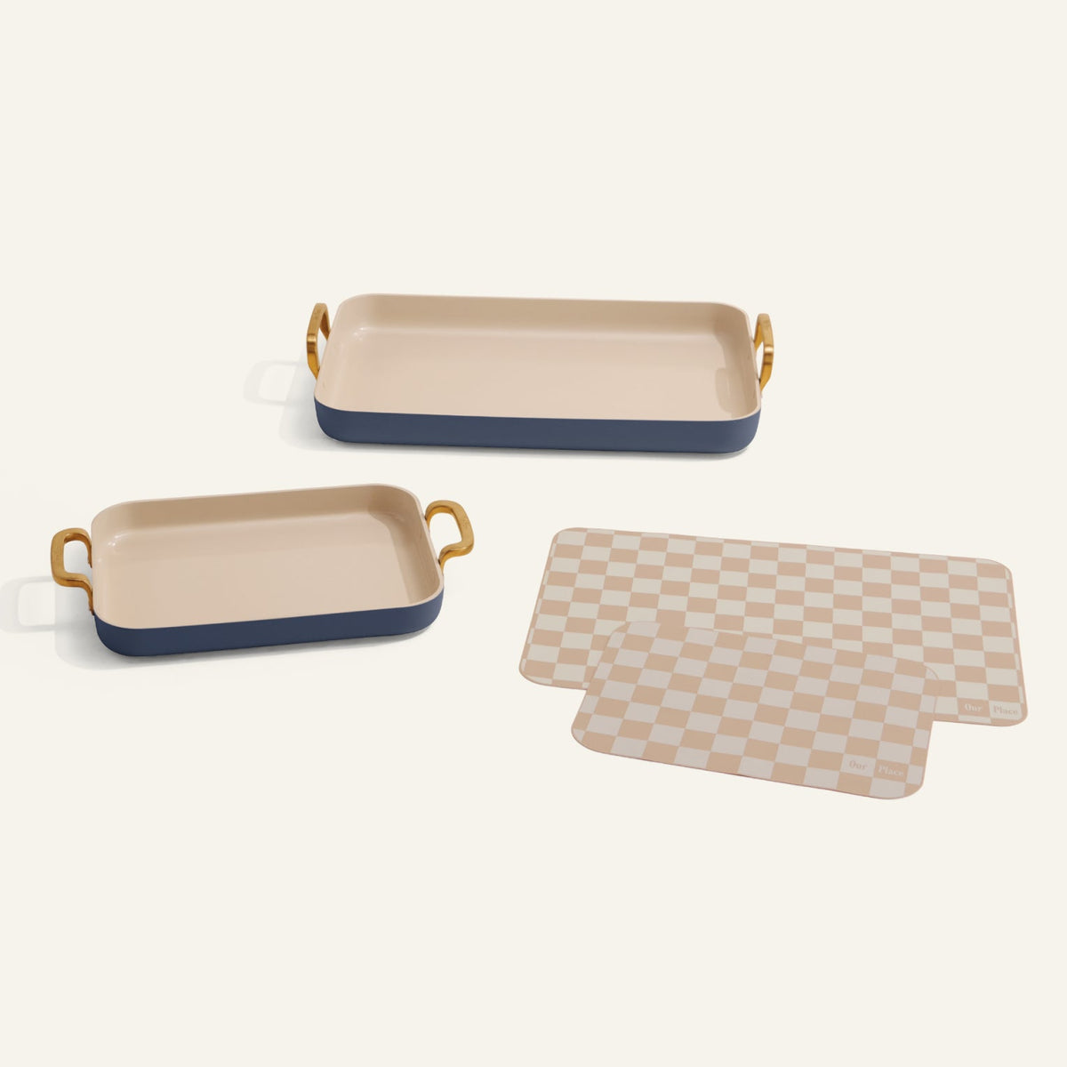 Set of two rectangular trays with gold handles and a checkered mat on a white background