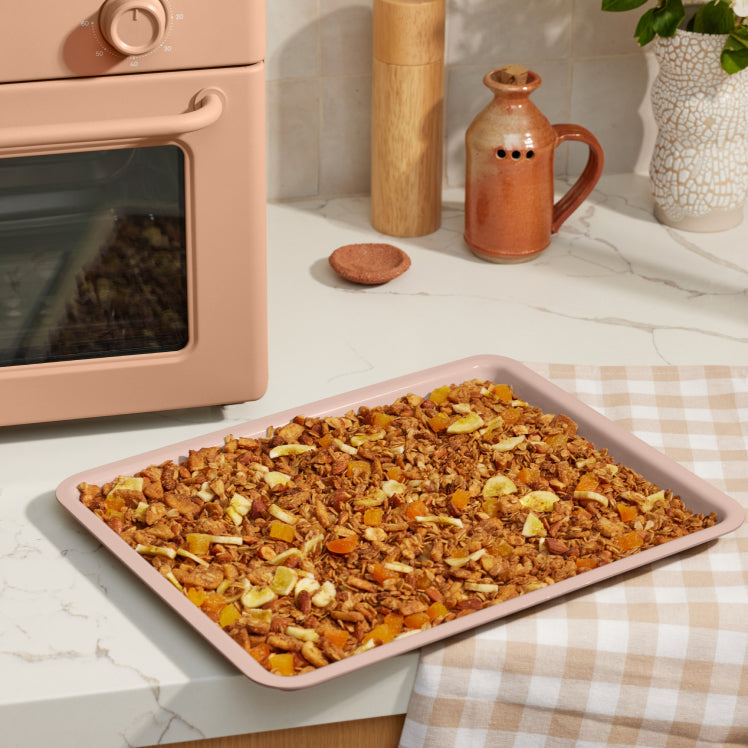 pink large wonder oven non toxic air fryer toaster oven tray on counter with baked granola