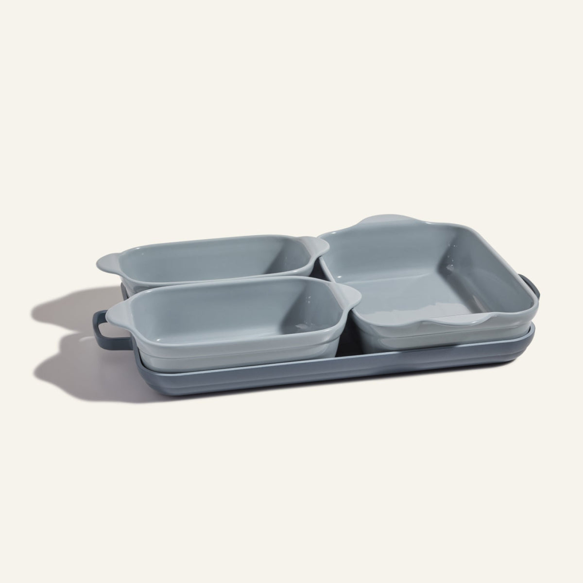 The Bakeware Set features four stylish gray ceramic baking dishes in various sizes, neatly stacked on a light background.