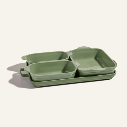 The Bakeware Set features four green ceramic baking dishes in assorted sizes, stacked on a light background, adding style to any oven cookware collection.