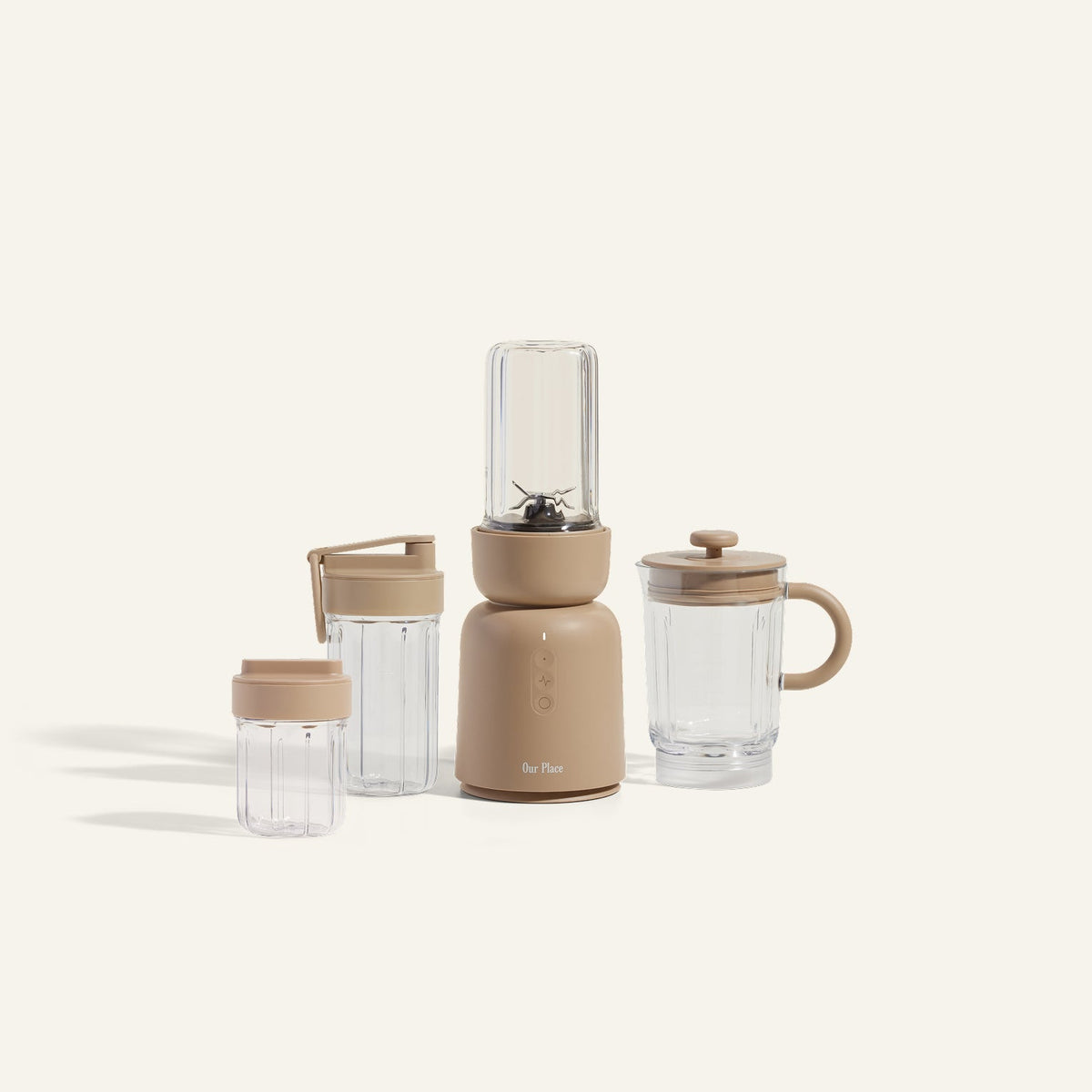 Portable blender set with beige base and clear cups on a white background